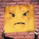 Poster of a frowning yellow cartoon face, held up by two hands.
